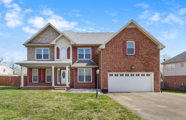 view of front of house featuring an attached garage, fence, concrete driveway, brick siding, and a front lawn