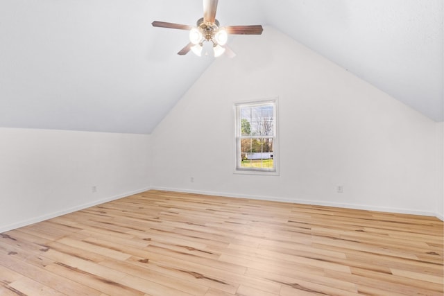bonus room with baseboards, light wood finished floors, vaulted ceiling, and a ceiling fan