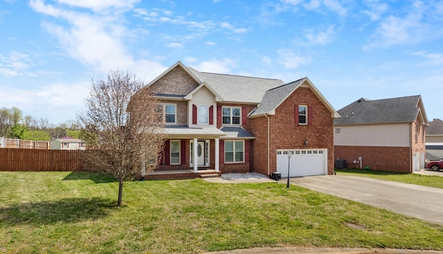view of front facade with an attached garage, fence, brick siding, a front lawn, and driveway