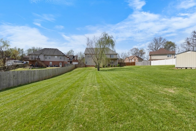 view of yard featuring an outbuilding and a fenced backyard