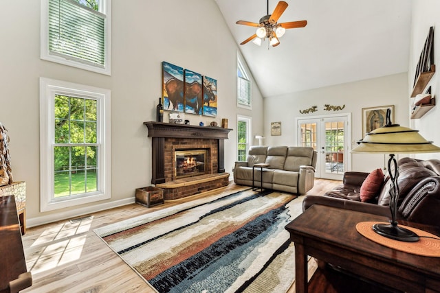 1132 Roseland Dr, Columbia, TN 38401 - living room with wood finished floors, high vaulted ceiling, a brick fireplace, baseboards, and ceiling fan