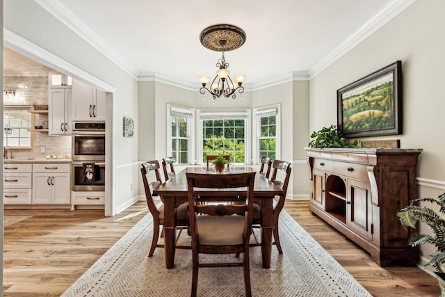 1132 Roseland Dr, Columbia, TN 38401 - dining room featuring baseboards, a notable chandelier, light wood finished floors, and crown molding