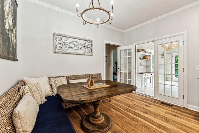 1132 Roseland Dr, Columbia, TN 38401 - dining space with french doors, wood finished floors, ornamental molding, visible vents, and a chandelier