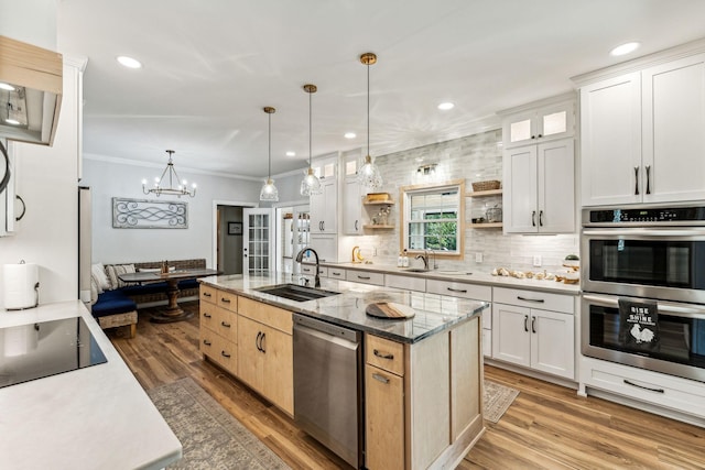 1132 Roseland Dr, Columbia, TN 38401 - kitchen with a sink, stainless steel appliances, open shelves, a center island with sink, and light wood-style flooring