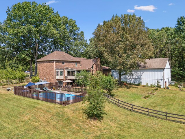 1132 Roseland Dr, Columbia, TN 38401 - rear view of house featuring a fenced backyard, a fenced in pool, and a lawn