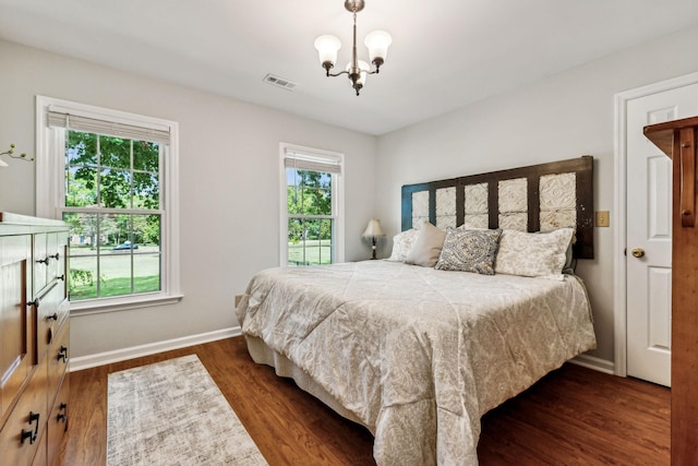 1132 Roseland Dr, Columbia, TN 38401 - bedroom with baseboards, an inviting chandelier, visible vents, and wood finished floors