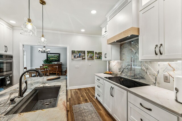 1132 Roseland Dr, Columbia, TN 38401 - kitchen featuring a sink, decorative light fixtures, backsplash, black electric cooktop, and premium range hood