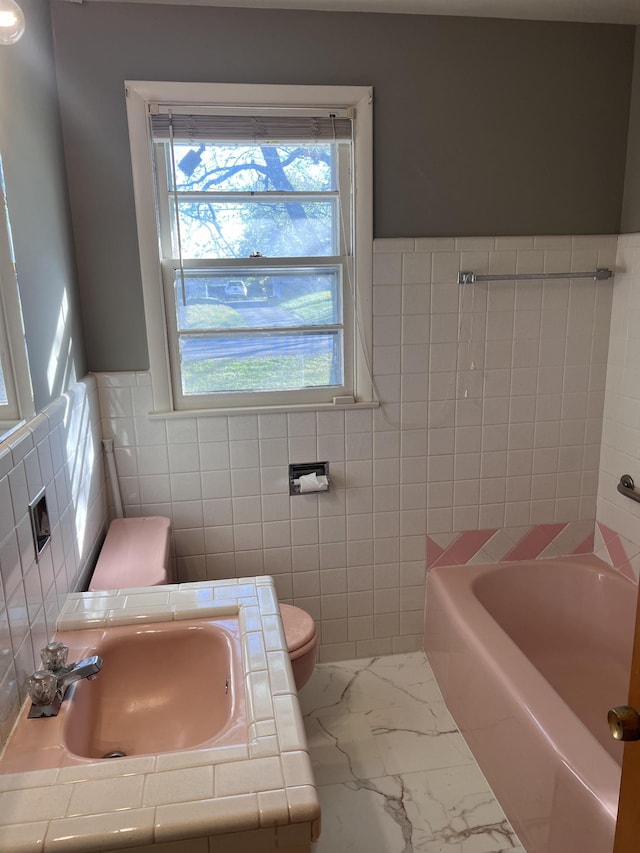 728 Robert Burns Dr, Nashville, TN 37217 - full bathroom featuring marble finish floor, toilet, a washtub, tile walls, and a sink