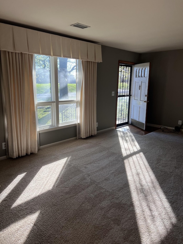 728 Robert Burns Dr, Nashville, TN 37217 - unfurnished living room with carpet, visible vents, baseboards, and a healthy amount of sunlight