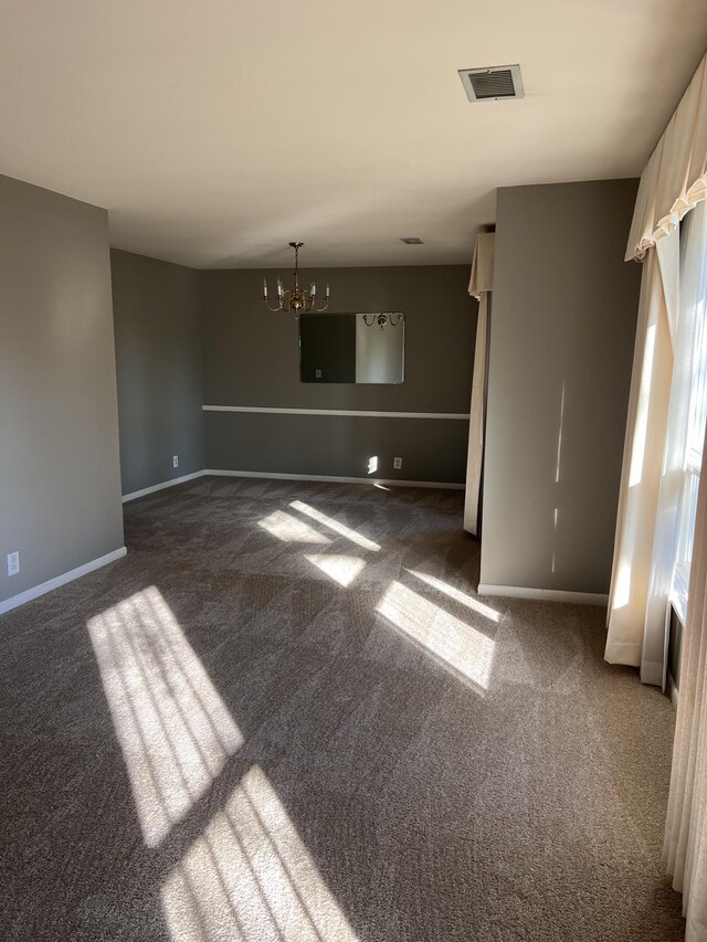 728 Robert Burns Dr, Nashville, TN 37217 - spare room with dark colored carpet, visible vents, baseboards, and an inviting chandelier