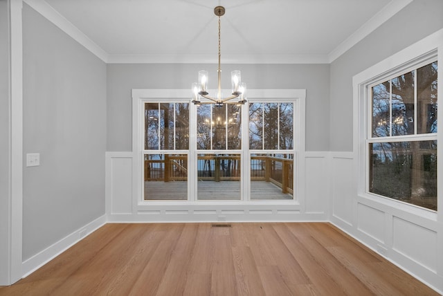 311 Riverview Dr, Dover, TN 37058 - unfurnished dining area featuring a decorative wall, light wood finished floors, a notable chandelier, and crown molding
