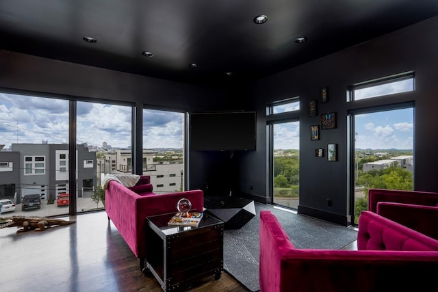 living room featuring recessed lighting, wood finished floors, and baseboards