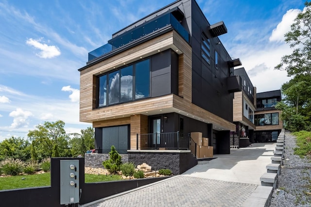 exterior space with an attached garage and decorative driveway