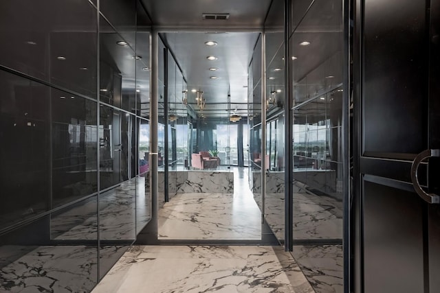 interior space featuring visible vents and marble finish floor
