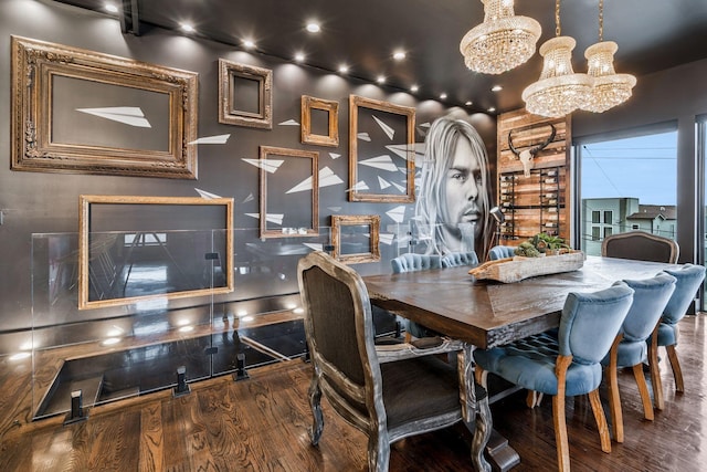 dining area featuring wood finished floors and an inviting chandelier