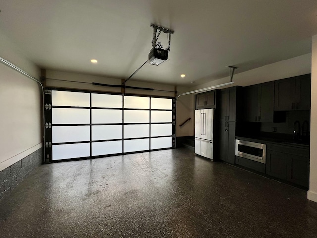 garage featuring a garage door opener, high quality fridge, and recessed lighting