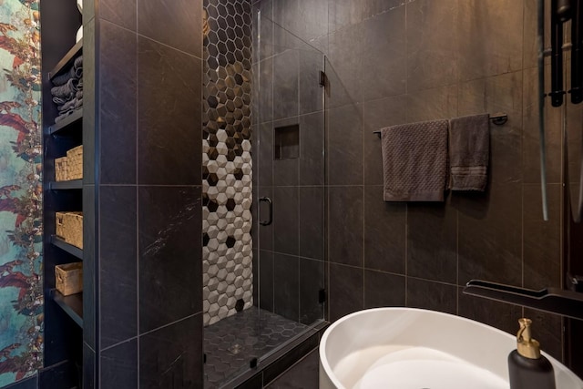 full bath featuring a shower stall and a soaking tub
