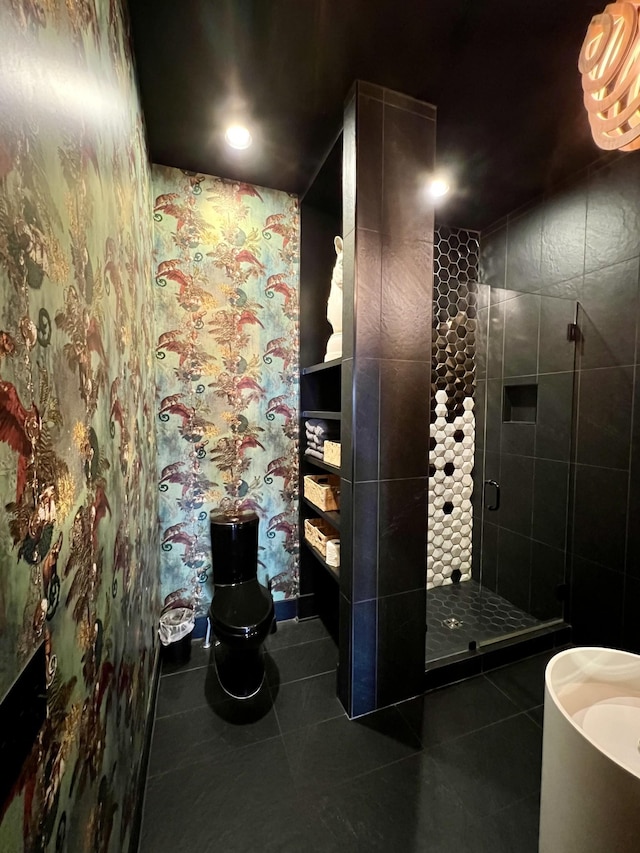 full bathroom featuring a shower stall, toilet, and tile patterned flooring
