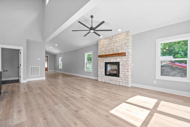 307 Riverview Dr, Dover, TN 37058 - unfurnished living room with a ceiling fan, a stone fireplace, light wood-type flooring, baseboards, and lofted ceiling