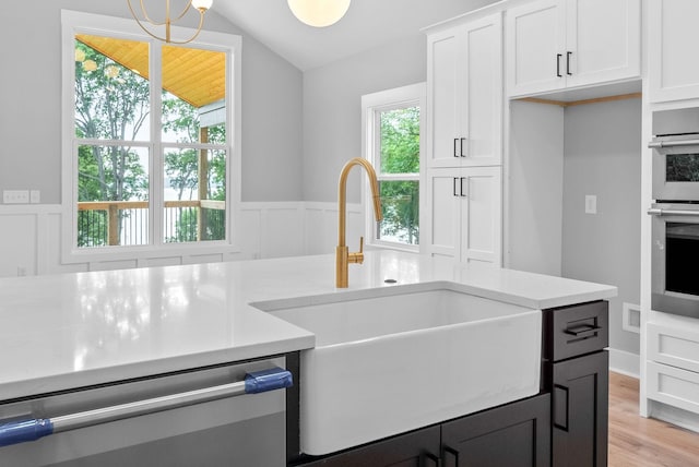 307 Riverview Dr, Dover, TN 37058 - kitchen featuring stainless steel appliances, lofted ceiling, a sink, light countertops, and white cabinets