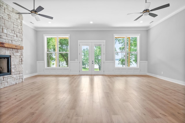 307 Riverview Dr, Dover, TN 37058 - unfurnished living room with a ceiling fan, ornamental molding, light wood finished floors, a wainscoted wall, and a fireplace