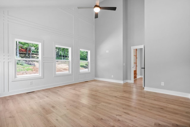307 Riverview Dr, Dover, TN 37058 - unfurnished living room with a high ceiling, a ceiling fan, light wood-style flooring, and baseboards