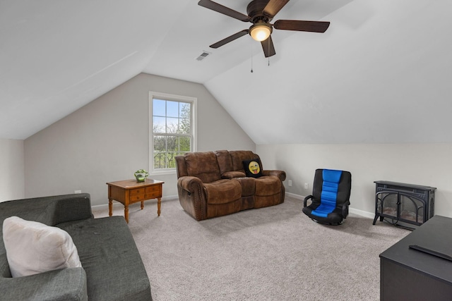 living area featuring baseboards, carpet flooring, ceiling fan, and lofted ceiling