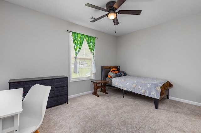 carpeted bedroom with baseboards and a ceiling fan