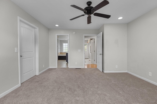 unfurnished bedroom with recessed lighting, ensuite bath, baseboards, and carpet floors