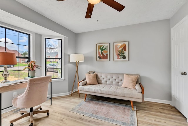 office featuring baseboards, ceiling fan, and wood finished floors