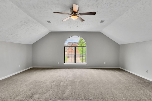 bonus room featuring carpet and a textured ceiling