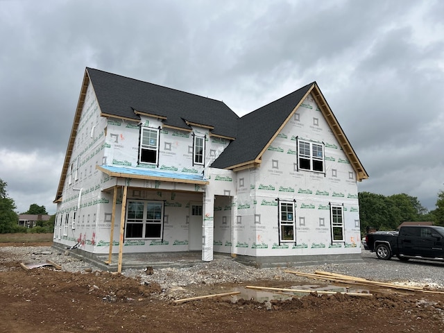 property in mid-construction featuring roof with shingles
