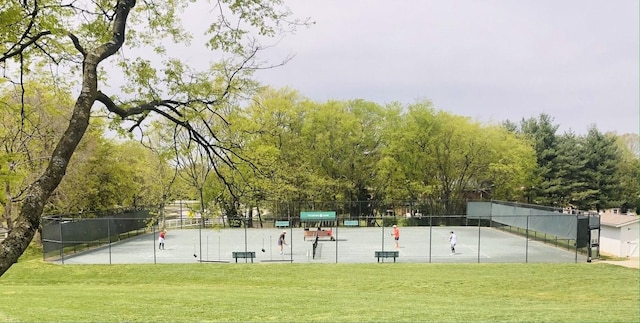 view of community with fence and a lawn