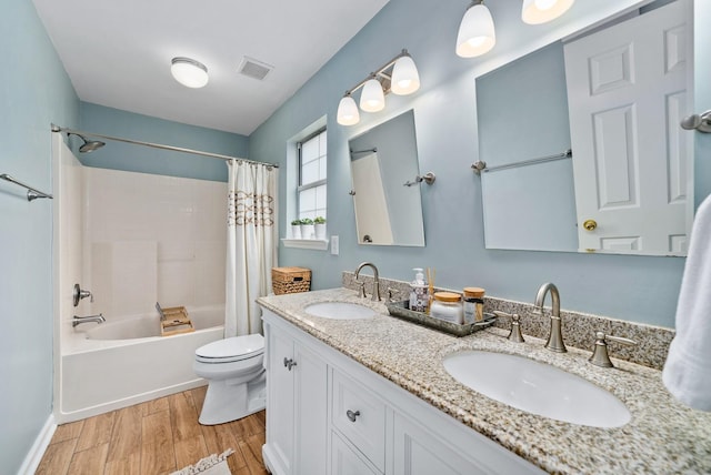 full bathroom featuring a sink, visible vents, toilet, and wood finished floors