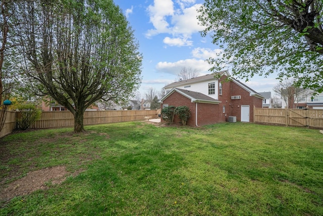 view of yard featuring a fenced backyard and central air condition unit