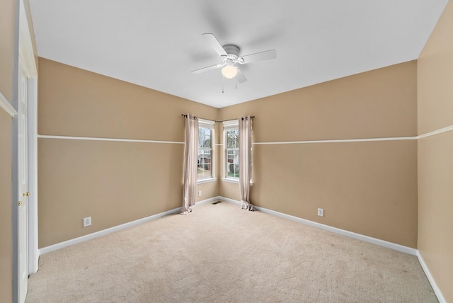 carpeted empty room with baseboards and ceiling fan