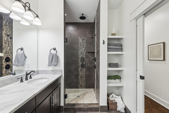 926 Acklen Ave Unit A, Nashville, TN 37203 - bathroom with a stall shower, wood finished floors, vanity, and baseboards