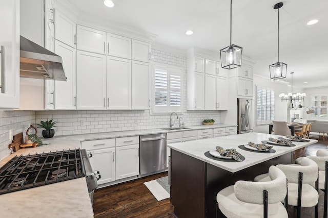 926 Acklen Ave Unit A, Nashville, TN 37203 - kitchen with white cabinetry, a breakfast bar area, stainless steel appliances, a sink, and ventilation hood