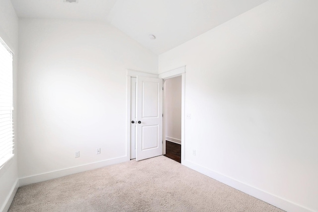 926 Acklen Ave Unit A, Nashville, TN 37203 - empty room featuring carpet floors, baseboards, and vaulted ceiling