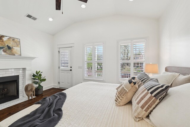 926 Acklen Ave Unit A, Nashville, TN 37203 - bedroom with visible vents, a brick fireplace, dark wood-style flooring, recessed lighting, and lofted ceiling