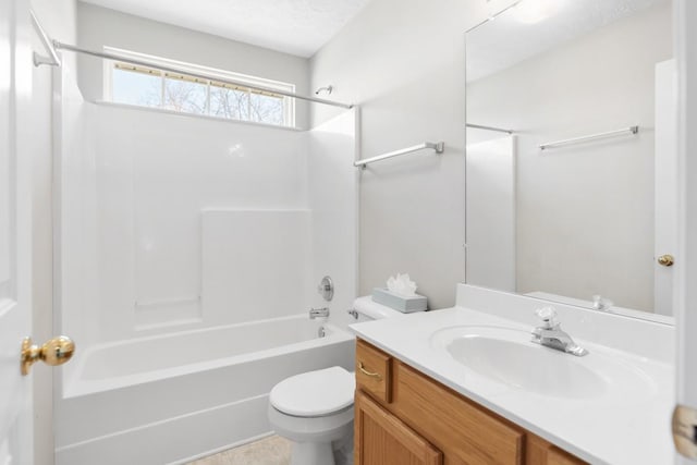 bathroom featuring toilet, vanity, and  shower combination