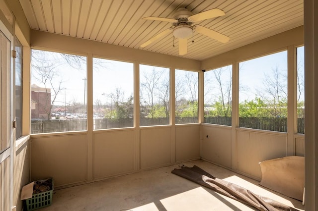 unfurnished sunroom featuring ceiling fan