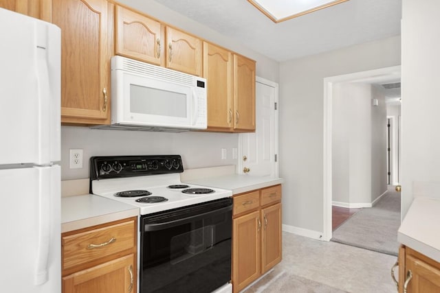 kitchen featuring baseboards, white appliances, light countertops, visible vents, and light brown cabinetry