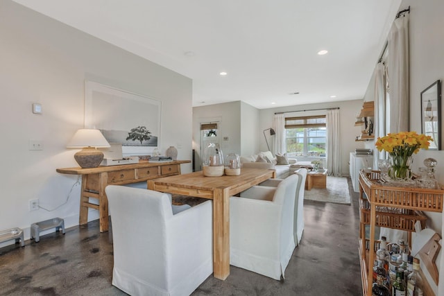 dining area with finished concrete flooring and recessed lighting