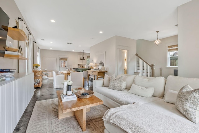 living area featuring wood finished floors, recessed lighting, and stairs