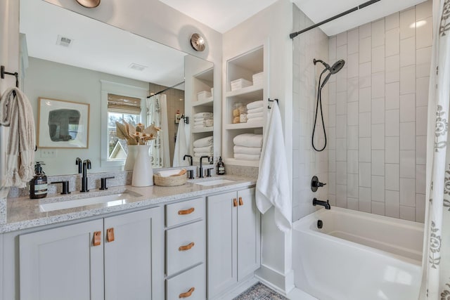 bathroom with shower / bath combo and double vanity