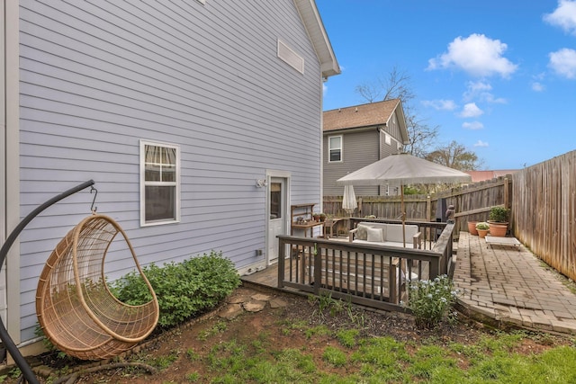 rear view of property featuring outdoor lounge area, a fenced backyard, and a wooden deck
