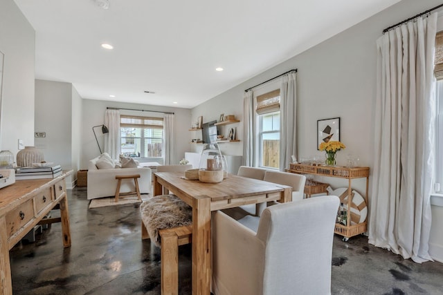 dining area with concrete floors and recessed lighting
