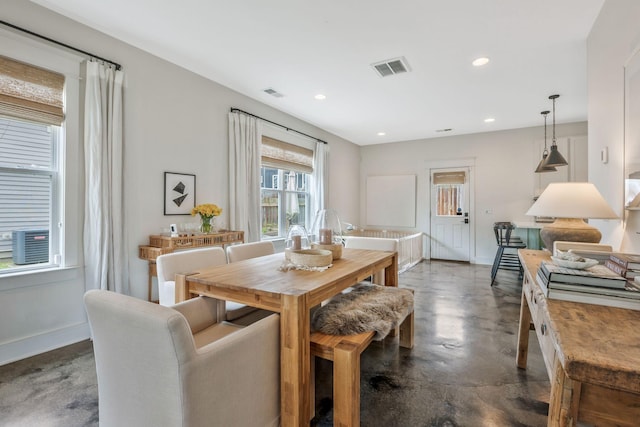 dining area featuring finished concrete floors, baseboards, and recessed lighting
