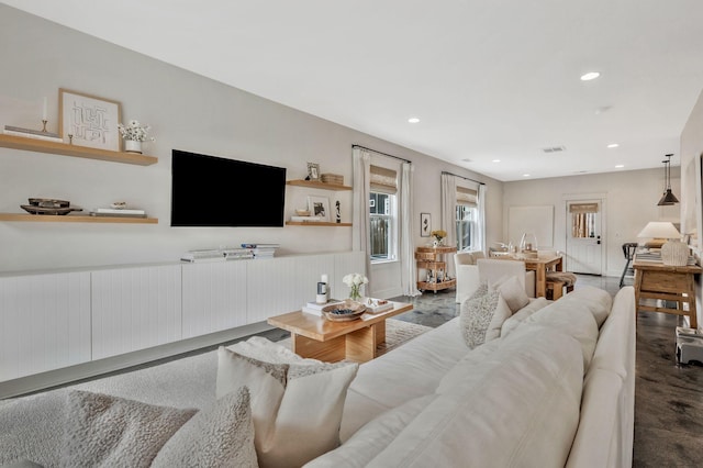 living area with recessed lighting and wainscoting